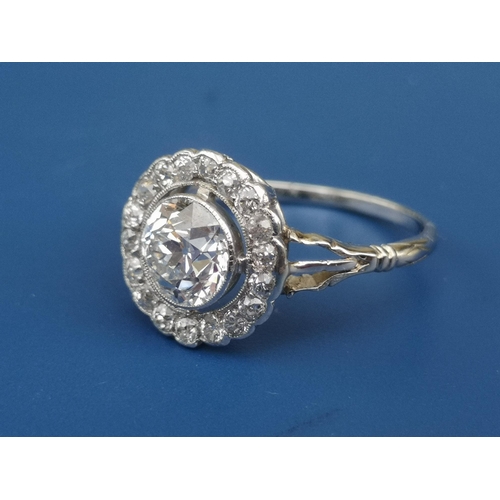 228 - An Edwardian diamond set cluster ring, the central old cut stone weighing in excess of one carat, on... 