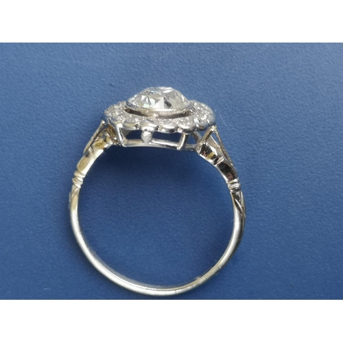 228 - An Edwardian diamond set cluster ring, the central old cut stone weighing in excess of one carat, on... 