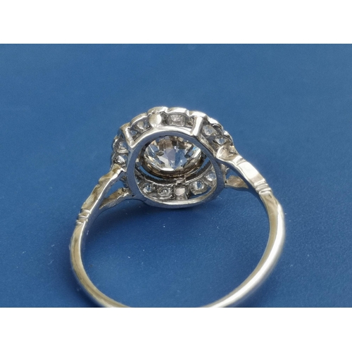 228 - An Edwardian diamond set cluster ring, the central old cut stone weighing in excess of one carat, on... 