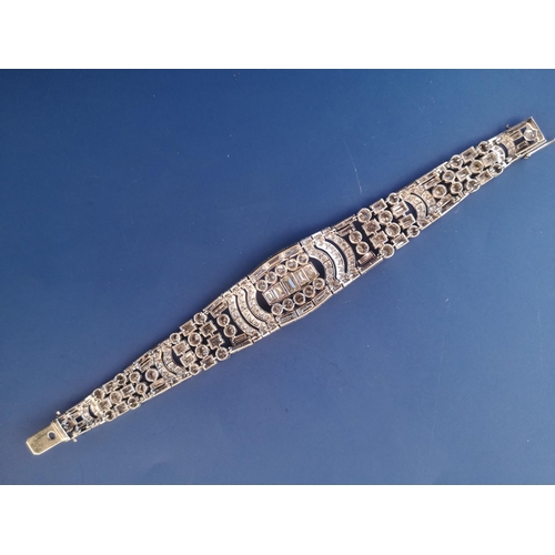 200 - An art deco diamond set tapering panel bracelet, of openwork form having numerous collet set round &... 