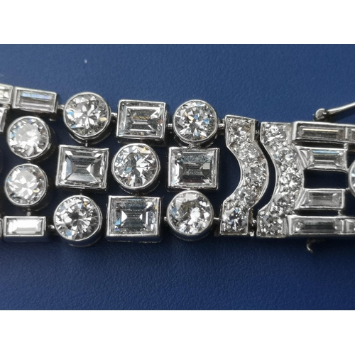 200 - An art deco diamond set tapering panel bracelet, of openwork form having numerous collet set round &... 