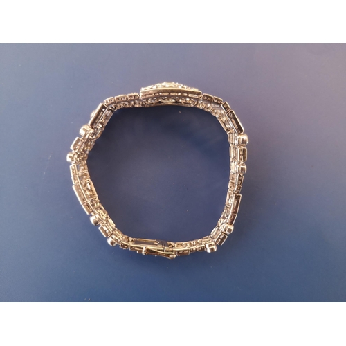 200 - An art deco diamond set tapering panel bracelet, of openwork form having numerous collet set round &... 