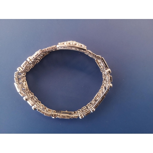 200 - An art deco diamond set tapering panel bracelet, of openwork form having numerous collet set round &... 