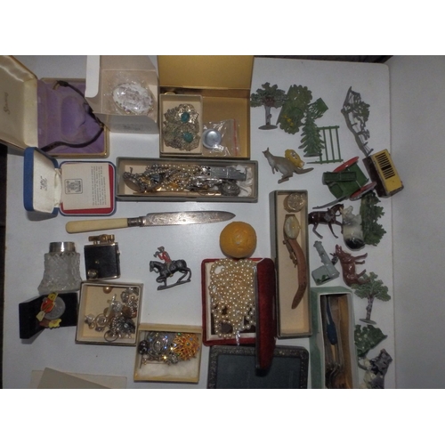 112 - A small suitcase containing some lead farmyard figures, costume jewellery and collectors' items.