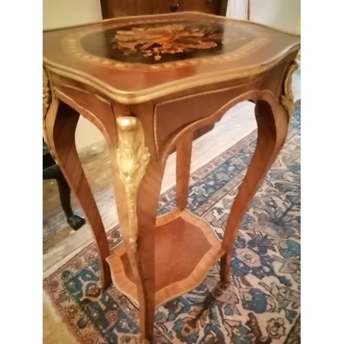 119 - A marquetry inlaid two tier walnut occasional table of shaped form with gilt metal mounts, Height 36... 