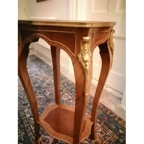 119 - A marquetry inlaid two tier walnut occasional table of shaped form with gilt metal mounts, Height 36... 