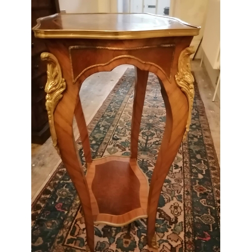 119 - A marquetry inlaid two tier walnut occasional table of shaped form with gilt metal mounts, Height 36... 