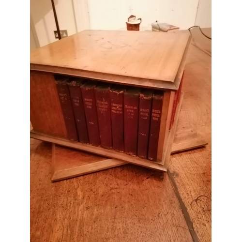 120 - A small Edwardian inlaid mahogany revolving square bookcase, together with 39 books including sets o... 