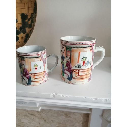 66 - Two matching 19thC Chinese famille rose mugs decorated figures on terraces - one rim chip.