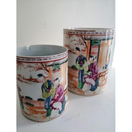 66 - Two matching 19thC Chinese famille rose mugs decorated figures on terraces - one rim chip.