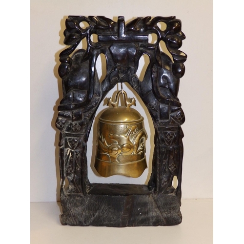 81 - A Chinese brass bell in silver-inlaid naturalistic wooden stand, 19