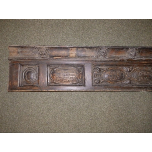 88 - An Edwardian carved oak frieze, the (incomplete) cornice applied with a series of male masks resembl... 