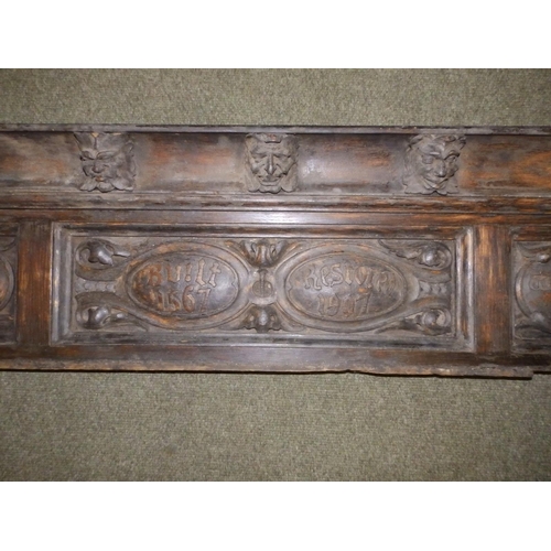 88 - An Edwardian carved oak frieze, the (incomplete) cornice applied with a series of male masks resembl... 