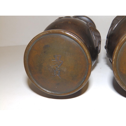 98 - A pair of Oriental bronze vases, signed to undersides. (2)