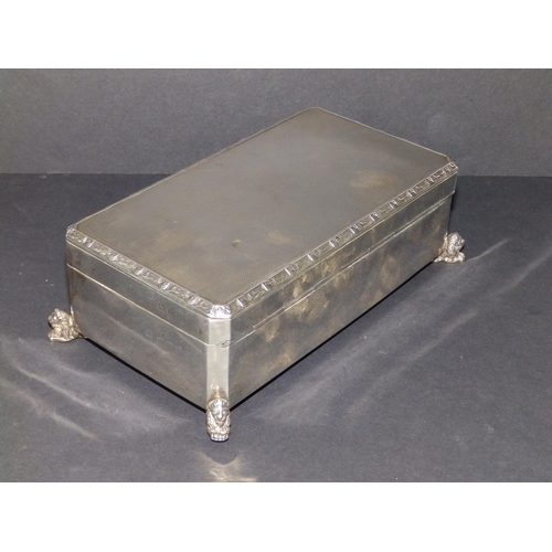 140 - A silver cigarette box, on cast recumbent lion feet, Birmingham 1936, 6.5