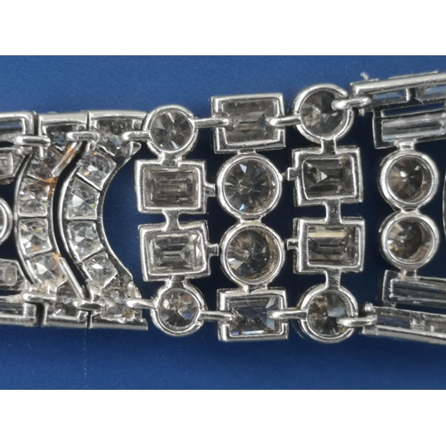 200 - An art deco diamond set tapering panel bracelet, of openwork form having numerous collet set round &... 