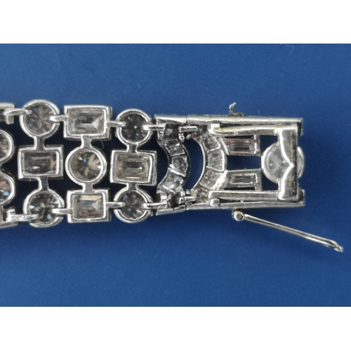 200 - An art deco diamond set tapering panel bracelet, of openwork form having numerous collet set round &... 