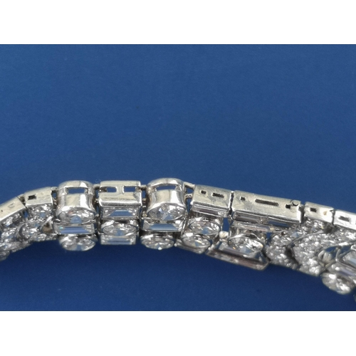 200 - An art deco diamond set tapering panel bracelet, of openwork form having numerous collet set round &... 