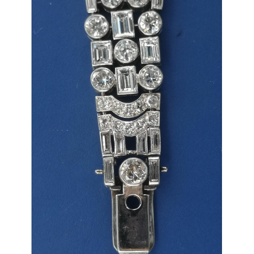 200 - An art deco diamond set tapering panel bracelet, of openwork form having numerous collet set round &... 