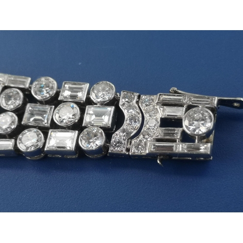 200 - An art deco diamond set tapering panel bracelet, of openwork form having numerous collet set round &... 