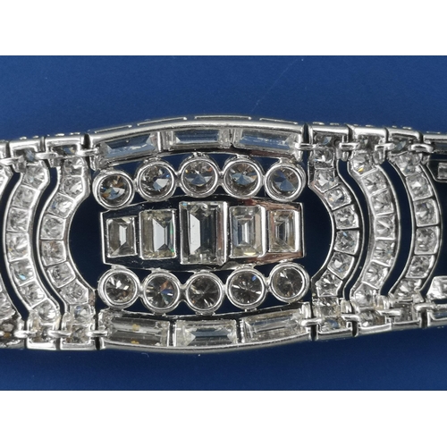 200 - An art deco diamond set tapering panel bracelet, of openwork form having numerous collet set round &... 