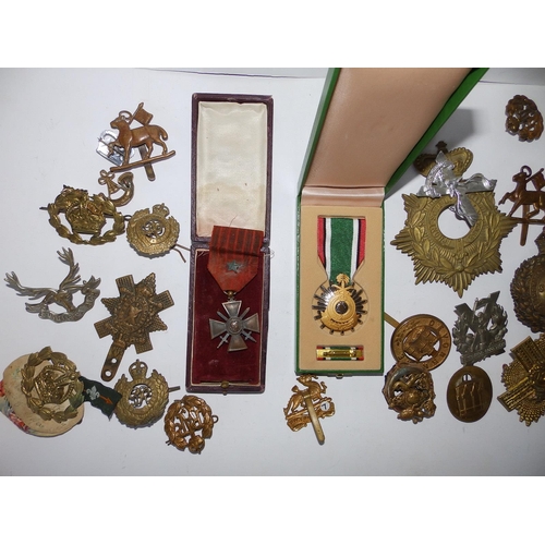 125a - A collection of military badges together with a French WWI medal and a Liberation of Kuwait medal.