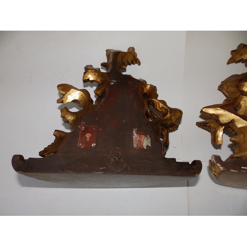 125c - A pair of Victorian carved giltwood wall brackets, each decorated profusely with flowerheads and a b... 