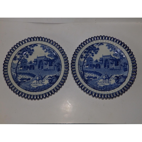 50a - A pair of blue & white plates with ozier pierced borders, each depicting a camel with rider in the f... 