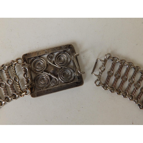 160 - A Malaysian Chinese white metal belt, of open link form with flowerhead to buckle,  33