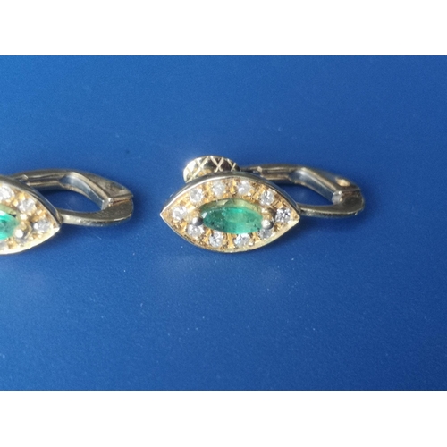 173 - A pair of emerald & diamond marquise cluster earrings in 750 yellow metal, the setings 10mm across. ... 