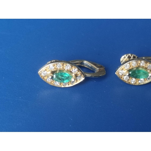 173 - A pair of emerald & diamond marquise cluster earrings in 750 yellow metal, the setings 10mm across. ... 