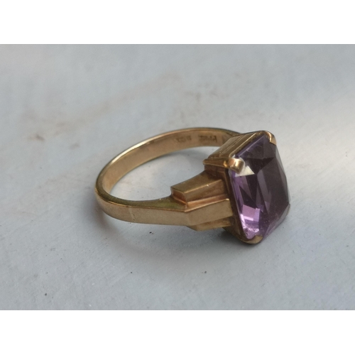 174 - A rectangular cut amethyst solitaire ring on 9ct yellow shank.  Finger size L.