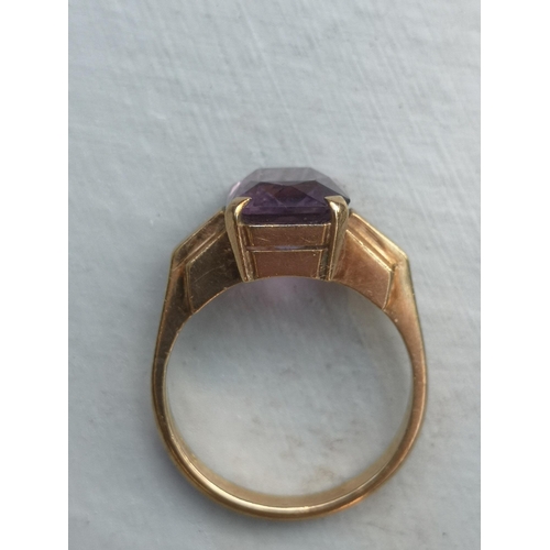 174 - A rectangular cut amethyst solitaire ring on 9ct yellow shank.  Finger size L.