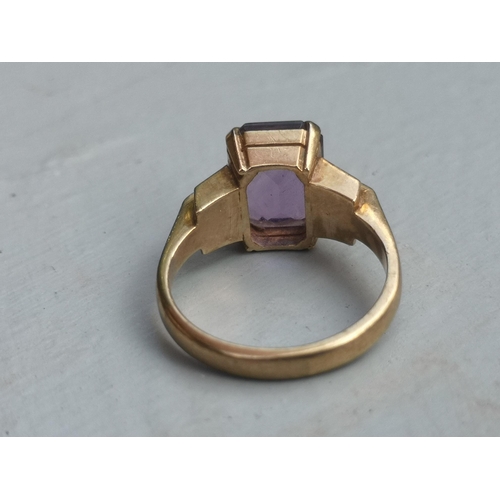 174 - A rectangular cut amethyst solitaire ring on 9ct yellow shank.  Finger size L.