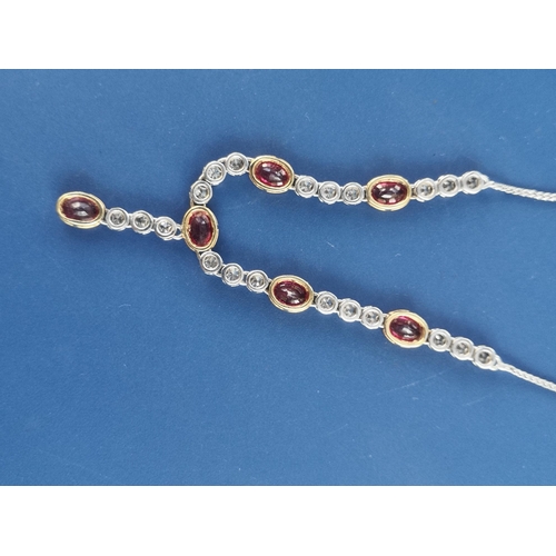 175 - A modern ruby & diamond set necklace in 18ct white & yellow gold, comprising six oval cut rubies in ... 