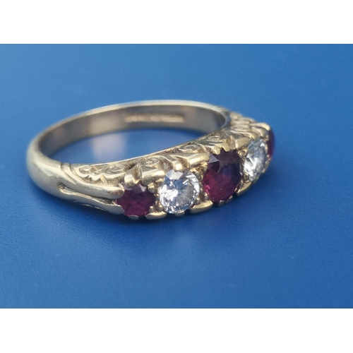 178 - A graduated five stone ruby & diamond set 18ct gold ring.  Finger size N.