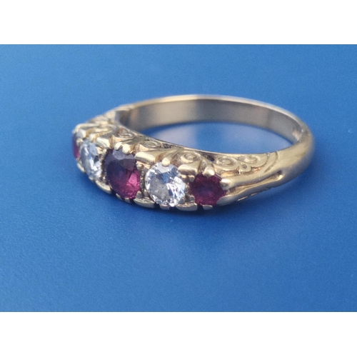 178 - A graduated five stone ruby & diamond set 18ct gold ring.  Finger size N.