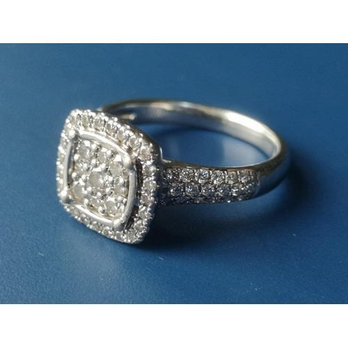 181 - A diamond set platinum cluster ring of square cushion form, pave set with numerous small diamonds, i... 