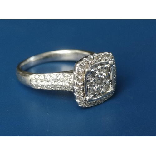 181 - A diamond set platinum cluster ring of square cushion form, pave set with numerous small diamonds, i... 