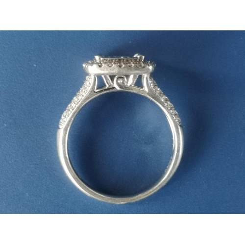 181 - A diamond set platinum cluster ring of square cushion form, pave set with numerous small diamonds, i... 