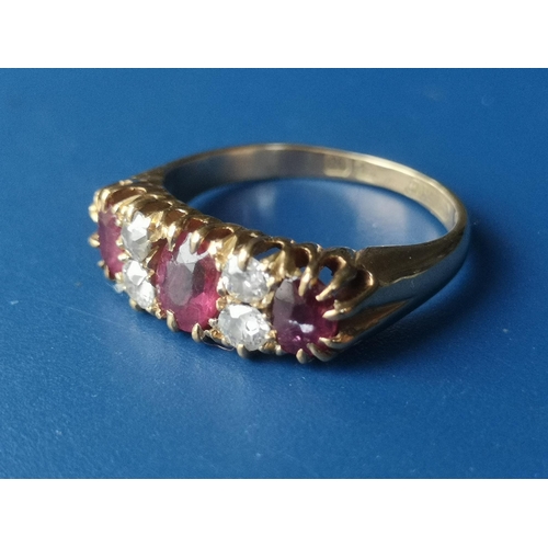 182 - An Edwardian seven stone ruby & diamond set gold ring.  Finger size K.