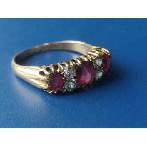 182 - An Edwardian seven stone ruby & diamond set gold ring.  Finger size K.