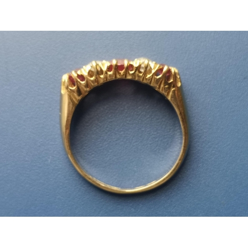 182 - An Edwardian seven stone ruby & diamond set gold ring.  Finger size K.