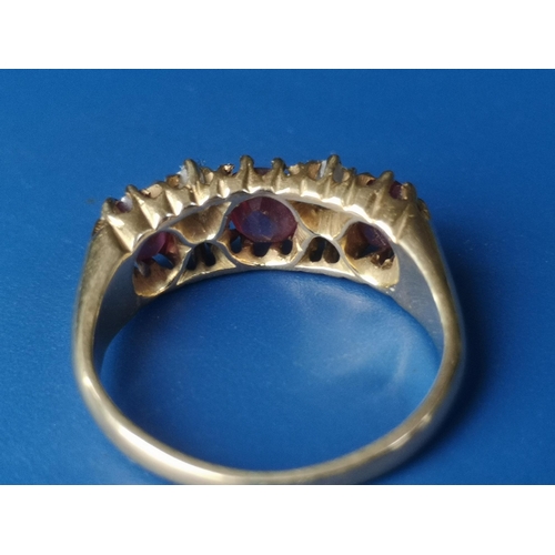 182 - An Edwardian seven stone ruby & diamond set gold ring.  Finger size K.