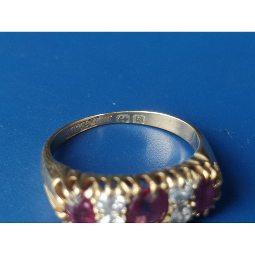 182 - An Edwardian seven stone ruby & diamond set gold ring.  Finger size K.