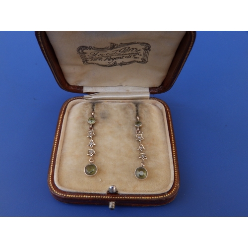 185 - A boxed antique pair of peridot & seed pearl set 9ct drop earrings, 1.25