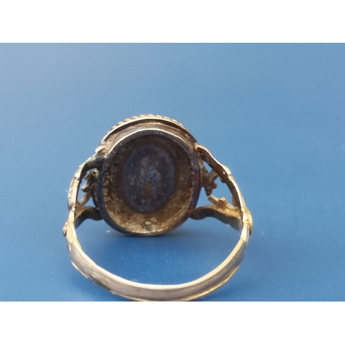 188 - An antique 18ct gold ring set with a  cabochon garnet,  London marks - slight damage to shoulder scr... 