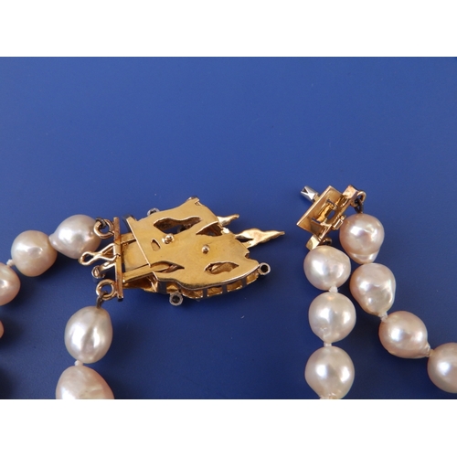 192 - A twin strand baroque pearl necklace, average girth of pearls between 8 & 9mm, the diamond set 18c c... 