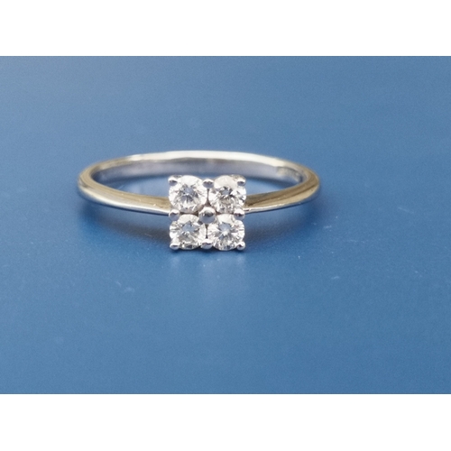 198 - A modern diamond ring set with four small diamonds of total weight approximately 0.25 carat - tests ... 