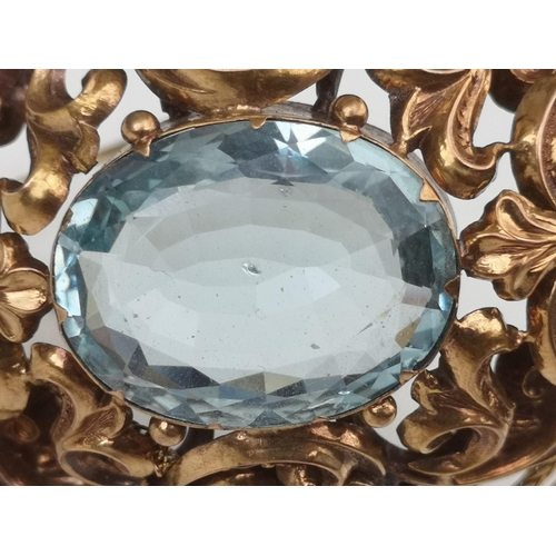 201 - A large Victorian aquamarine set brooch, of oval open scroll form, set with a large faceted oval aqu... 